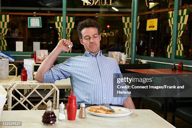 man in cafe with empty plate - person eating empty plate stock pictures, royalty-free photos & images