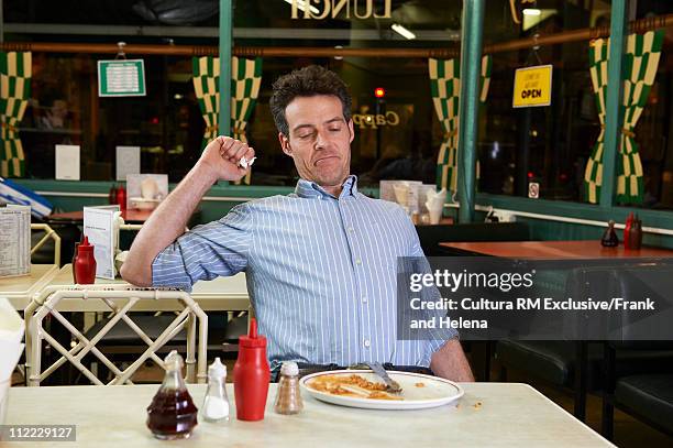 man in cafe with empty plate - men bulge imagens e fotografias de stock