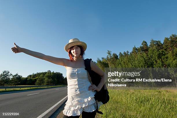 young girl thumb a lift on the road - latvia girls stock pictures, royalty-free photos & images