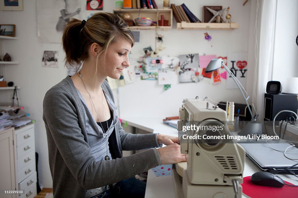 Young woman with sewing machine