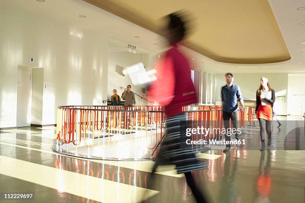 germany, leipzig, university students walking through corridor (blurred motion) - saxony stock pictures, royalty-free photos & images