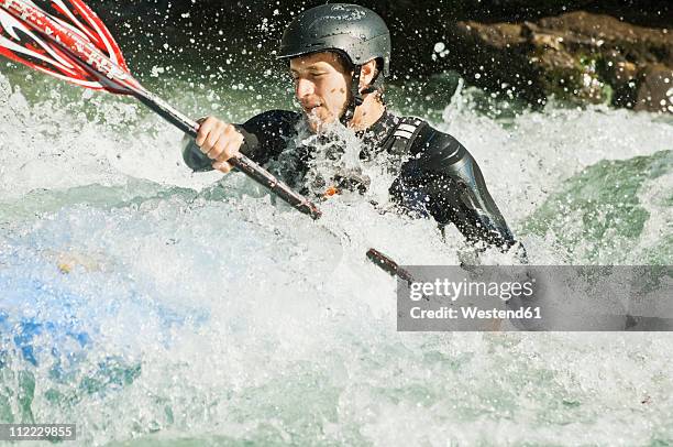 austria, salzburger land, man kayaking in lammer river - kayak barco de remos fotografías e imágenes de stock