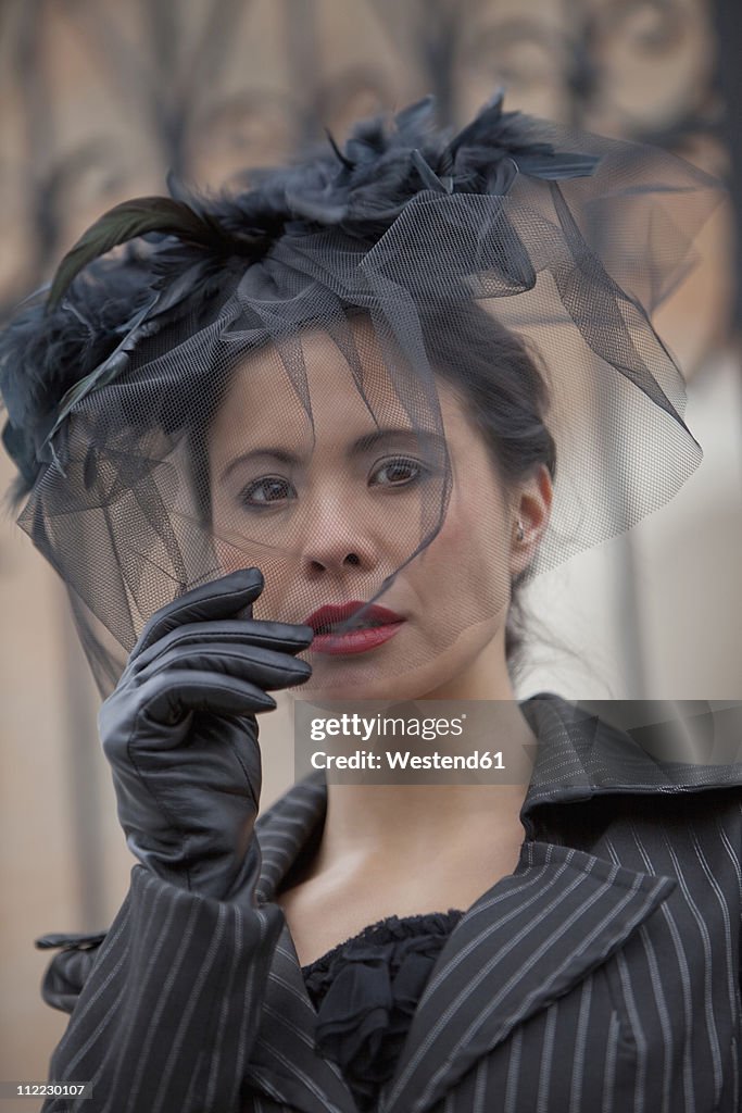 Germany, Bavaria, Young woman holding net, portrait