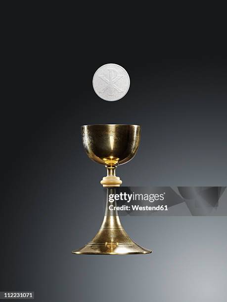 chalice and host against black background - chalice stock pictures, royalty-free photos & images