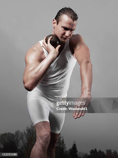 germany, augsburg, young man preparing for short-put - shot put stock pictures, royalty-free photos & images