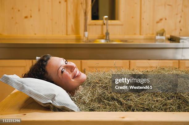 italy, south tyrol, woman having hay bath in hotel urthaler - 干し草 ストックフォトと画像