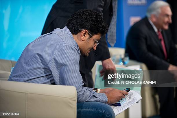 Egyptian Google executive Wael Ghonim checks his cellphone as he takes part in a roundtable discussion entitled Youth, Jobs, and Inclusive Growth in...