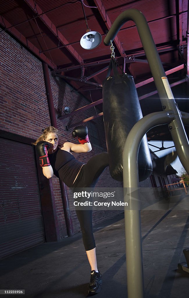 A teenage girl trains for mixed martial arts outside a warehouse in Birmingham, Alabama.
