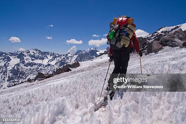 a man ski mountaineering through penitentes on volcan san jose in the andes mountains of chile - penitentes stockfoto's en -beelden