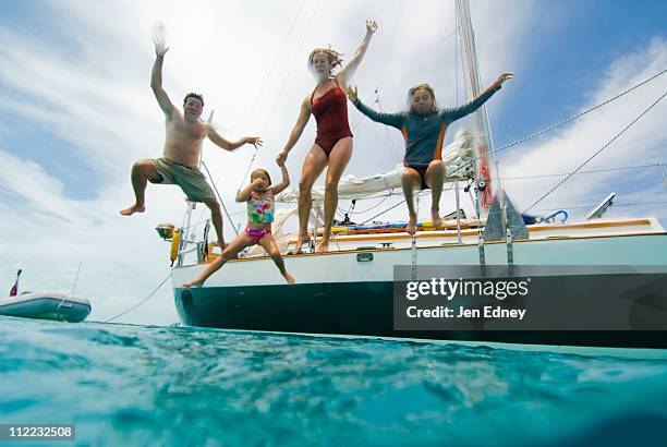 a family jumping off their boat - georgetown stock pictures, royalty-free photos & images