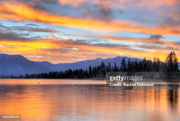 a brilliant fall sunrise is reflected in lake tahoe, california. - hilton head stock pictures, royalty-free photos & images