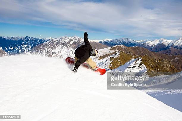 a male snowboarder blasts a heel side turn while snowboarding at coronet peak in queenstown, new zealand. - queenstown 個照片及圖片檔