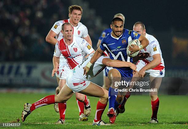 Thomas Leuluai of Wigan Warriors is tackled by Liam Watts of Hull Kingston Rovers during the Engage Super League match between Hull Kingston Rovers...
