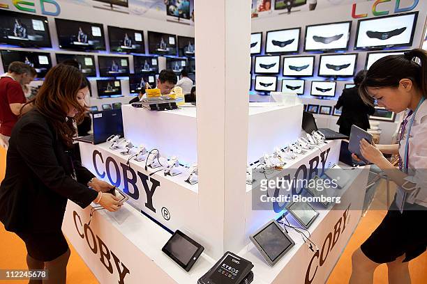Coby Electronics International Ltd. Representatives arrange their booth during the Canton Trade Fair in Guangzhou, Guangdong province, China, on...