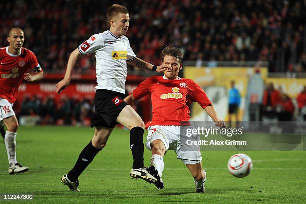 Marco Reus of M'Gladbach is hit in the penalty box by Eugen Polanski of Mainz during the Bundesliga match between FSV Mainz 05 and Borussia...