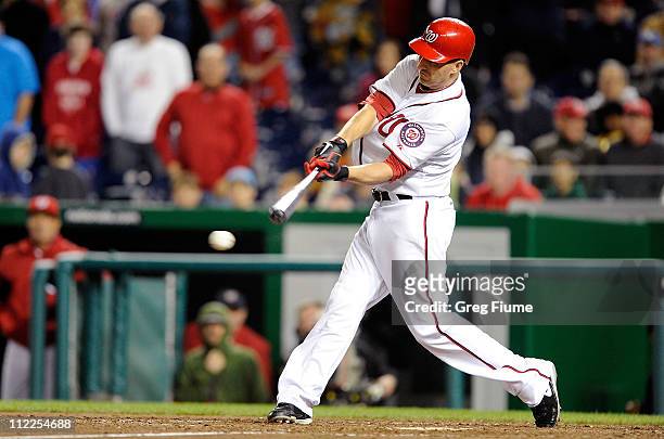 Adam LaRoche of the Washington Nationals drives in the winning run in the tenth inning against the Milwaukee Brewers at Nationals Park on April 15,...