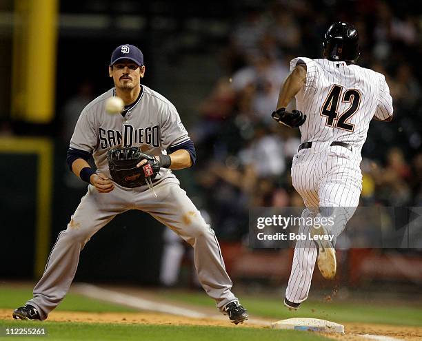 Michael Bourn of the Houston Astros beats out a sacrifice bunt as first baseman Jorge Cantu of the San Diego Padres waits for the ball at Minute Maid...