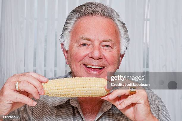 senior man eating corn on the cob - corn cob stock pictures, royalty-free photos & images