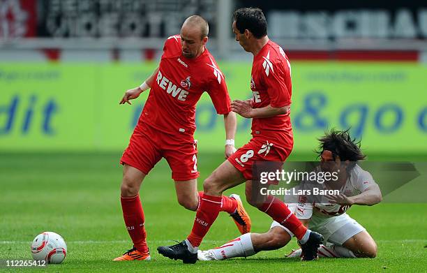 Shinji Okazaki of Stuttgart challenges Miso Brecko and Petit of Koeln during the Bundesliga match between 1. FC Koeln and VfB Suttgart at...