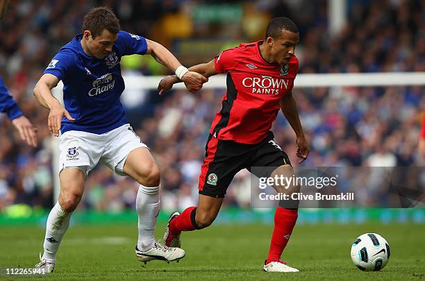 Martin Olsson of Blackburn Rovers attempts to move away from Diniyar Bilyaletdinov of Everton during the Barclays Premier League match between...