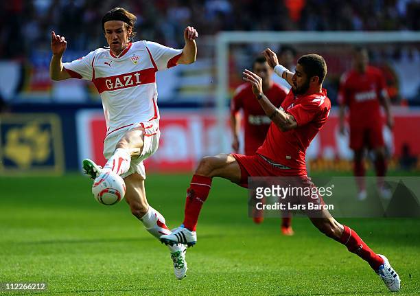 Christian Gentner of Stuttgart is challenged by Youssef Mohamad of Koeln during the Bundesliga match between 1. FC Koeln and VfB Suttgart at...