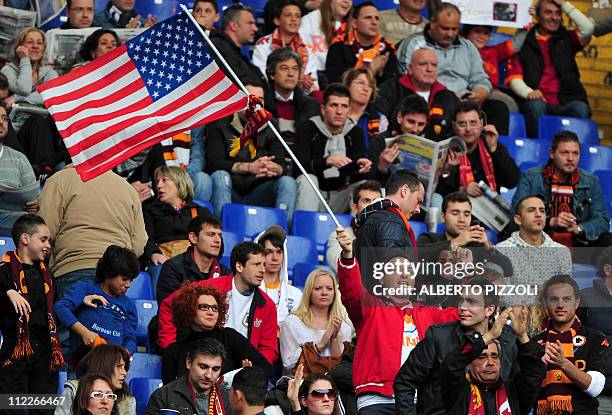 Roma team supporter waves a US flag prior to the Italian serie A football match opposing Roma and Palermo, at the Olympic stadium in Rome, on April...