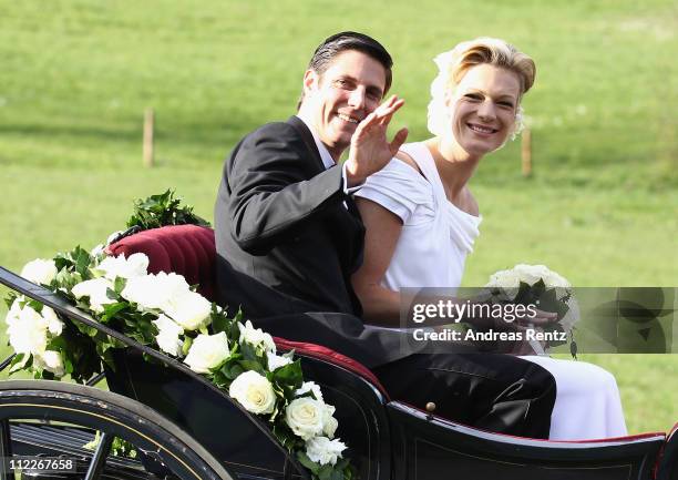 Maria Hoefl-Riesch and her husband Marcus Hoefl smile after their church wedding at the Pfarrkirche on April 16, 2011 in Going am Wilden Kaiser,...