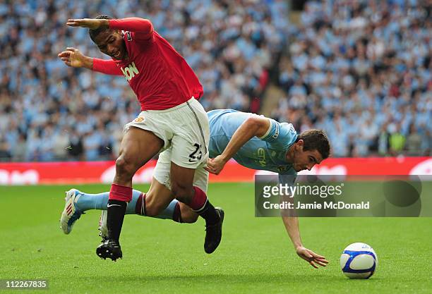 Aleksandar Kolarov of Manchester City and Antonio Valencia of Manchester United clash during the FA Cup sponsored by E.ON semi final match between...
