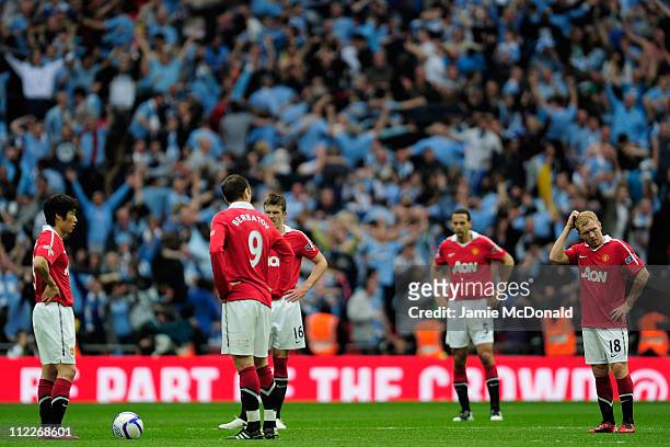 Man Utd players react after Yaya Toure of Manchester City scored the opening goal during the FA Cup sponsored by E.ON semi final match between...