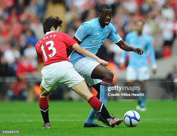 Ji-Sung Park of Manchester United tackles Yaya Toure of Manchester City during the FA Cup sponsored by E.ON semi final match between Manchester City...