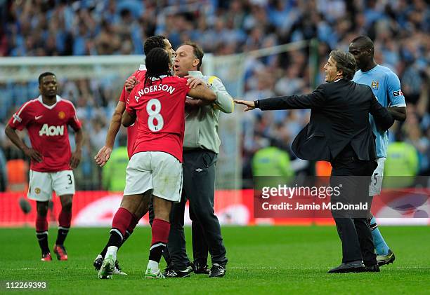 David Platt of Man City holds back Anderson and Rio Ferdinand of Man Utd at the final whistle during the FA Cup sponsored by E.ON semi final match...