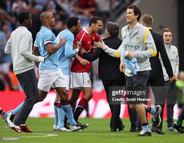 Rio Ferdinand of Man Utd clashes with Roberto Mancini, manager of Manchester City during the FA Cup sponsored by E.ON semi final match between...