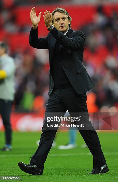 Roberto Mancini, manager of Manchester City applauds the fans during the FA Cup sponsored by E.ON semi final match between Manchester City and...