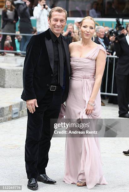 Markus Othmer and Katja Wunderlich arrive for the church wedding of Maria Hoefl-Riesch and Marcus Hoefl at the Pfarrkirche on April 16, 2011 in Going...