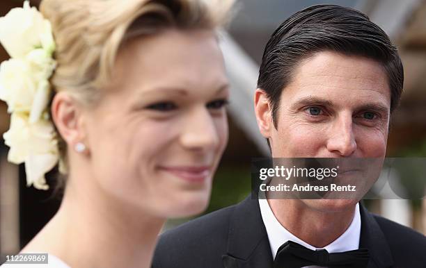 Maria Hoefl-Riesch and her husband Marcus Hoefl smile after their church wedding at the Pfarrkirche on April 16, 2011 in Going am Wilden Kaiser,...