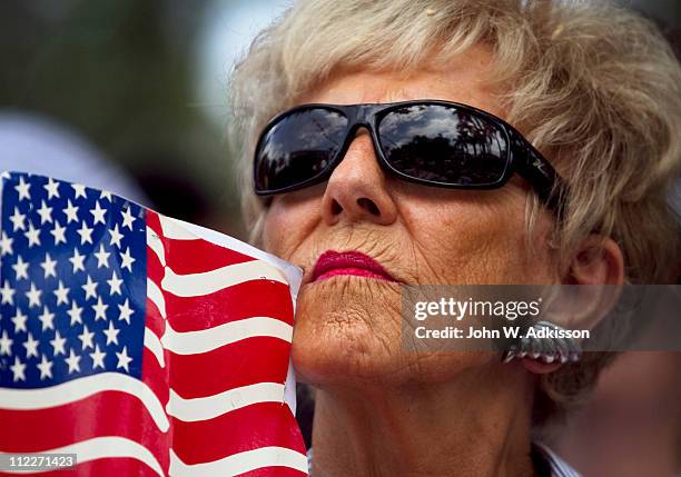 Supporter listens to billionaire Donald Trump speak at the 2011 Palm Beach County Tax Day Tea Party on April 16, 2011 at Sanborn Square in Boca...