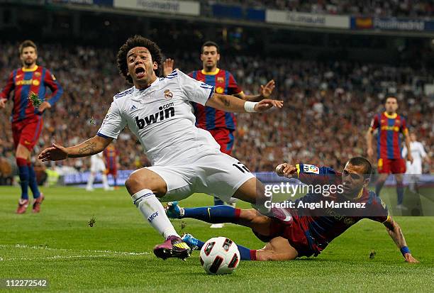 Daniel Alves of Barcelona fouls Marcelo Vieira of Real Madrid in the penalty area during the La Liga match between Real Madrid and Barcelona at...