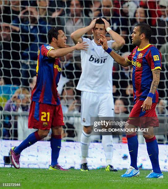 Barcelona's Brazilian defender Adriano and Barcelona's Brazilian defender Dani Alves react after Barcelona's Argentinian forward Lionel Messi scored...