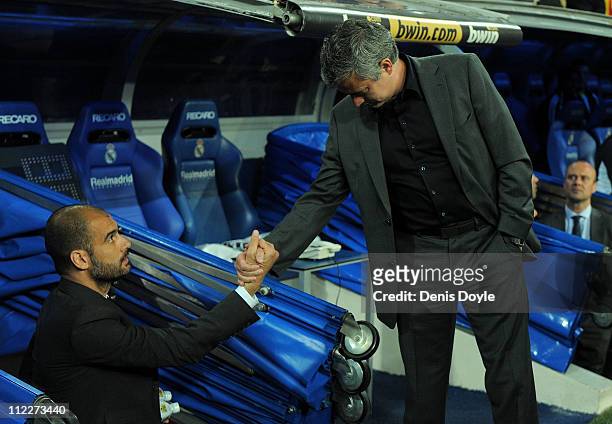 Barcelona manager Josep Guardiola shakes hands with head coach Jose Mourinho of Real Madrid before the start of the La Liga match between Real Madrid...