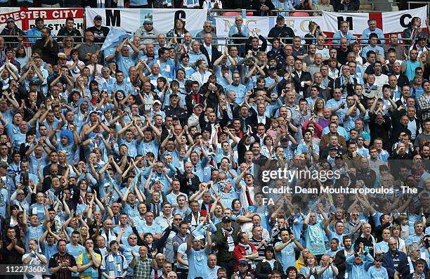 Manchester City fans cheer during the FA Cup sponsored by E.ON semi final match between Manchester City and Manchester United at Wembley Stadium on...