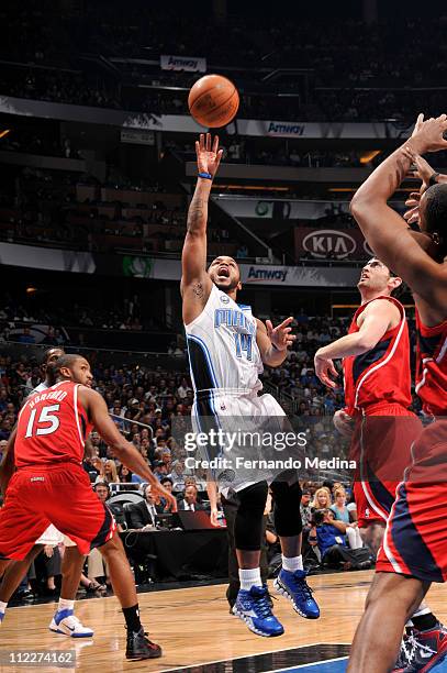 Jameer Nelson of the Orlando Magic shoots against Kirk Hinrich of the Atlanta Hawks in Game One of the Eastern Conference Quarterfinals in the 2011...