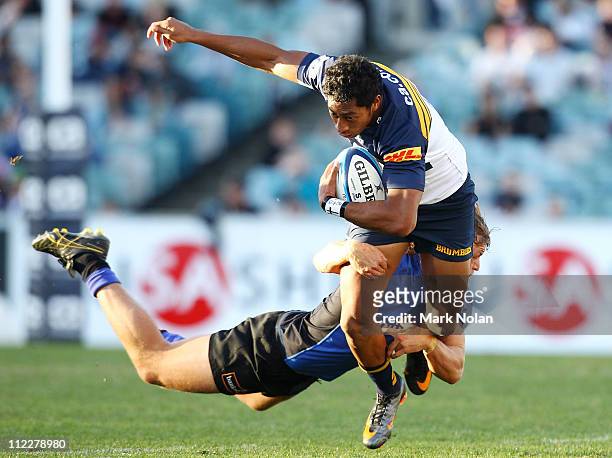 Nick Cummins of the Force tackles Francis Fainifo of the Brumbies during the round nine Super Rugby match between the Brumbies and the Force at...