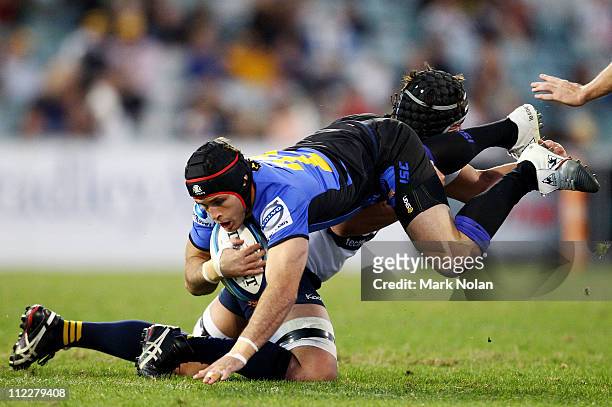 Gene Fairbanks of the Force is tackled during the round nine Super Rugby match between the Brumbies and the Force at Canberra Stadium on April 17,...