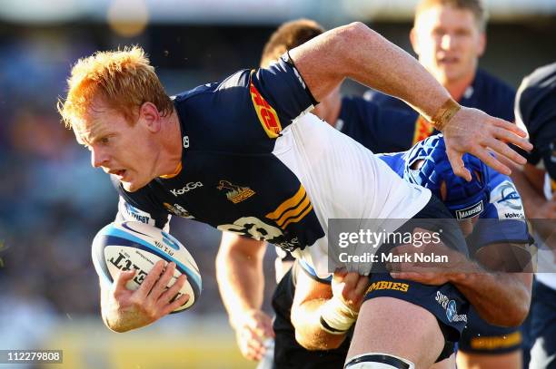 Peter Kimlin of the Brumbies is tackled during the round nine Super Rugby match between the Brumbies and the Force at Canberra Stadium on April 17,...