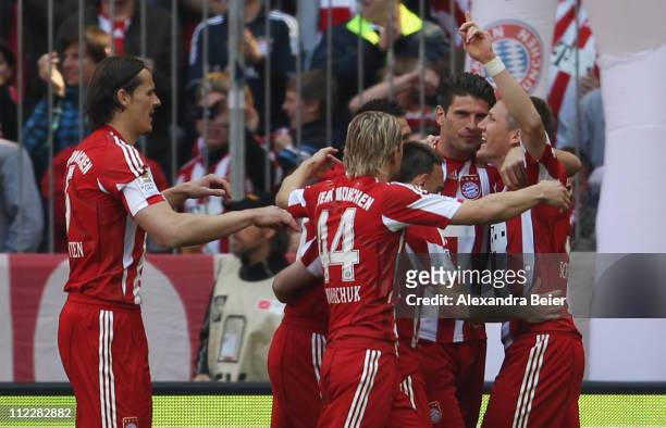 Bastian Schweinsteiger of Bayern Muenchen celebrates his first goal together with his teammates Daniel van Buyten, Anatoliy Tymoshchuk, Franck...