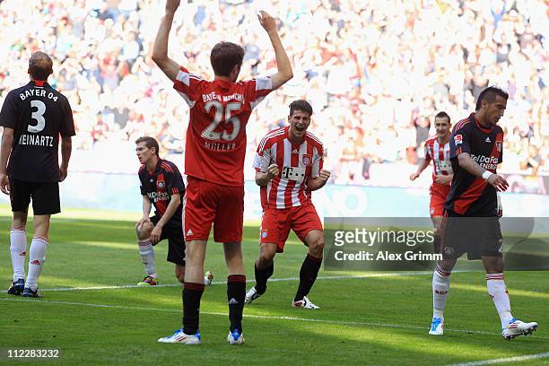 Mario Gomez of Muenchen celebrates his team's second goal with team mates Thomas Mueller as Stefan Reinartz, Daniel Schwaab and Arturo Vidal of...