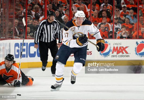 Tyler Myers of the Buffalo Sabres skates the puck out from a fallen Claude Giroux of the Philadelphia Flyers in Game One of the Eastern Conference...