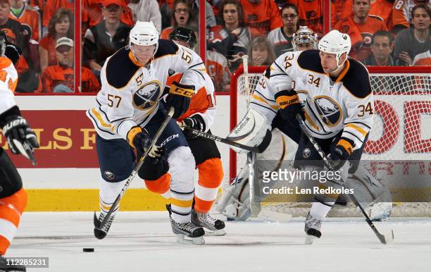 Tyler Myers and Chris Butler of the Buffalo Sabres skate the puck against the Philadelphia Flyers in Game One of the Eastern Conference Quarterfinals...