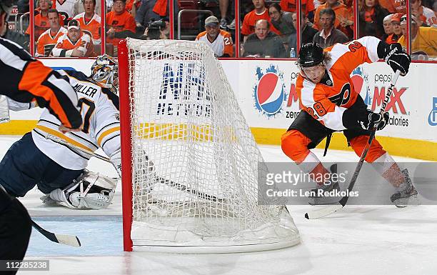 Claude Giroux of the Philadelphia Flyers skates the puck behind the net of Ryan Miller of the Buffalo Sabres in Game One of the Eastern Conference...