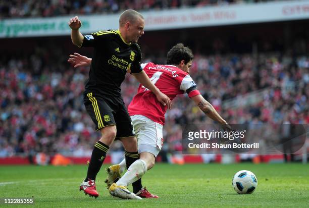 Jay Spearing of Liverpool tackles Cesc Fabregas of Arsenal and gives away a penalty kick during the Barclays Premier League match between Arsenal and...